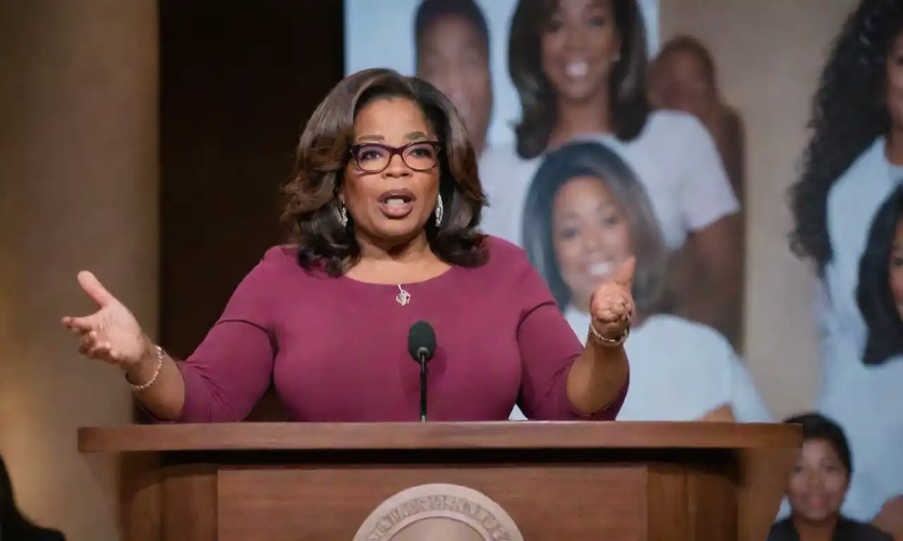 Oprah Winfrey confidently speaking at a podium, surrounded by images of influential women in entrepreneurship.