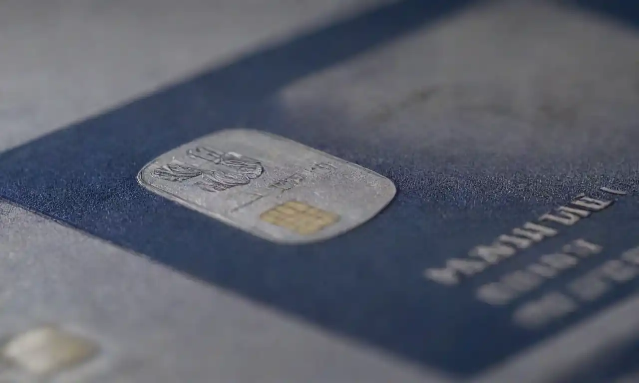 Close-up of the Navy Federal Platinum card with financial metrics and features highlighted.